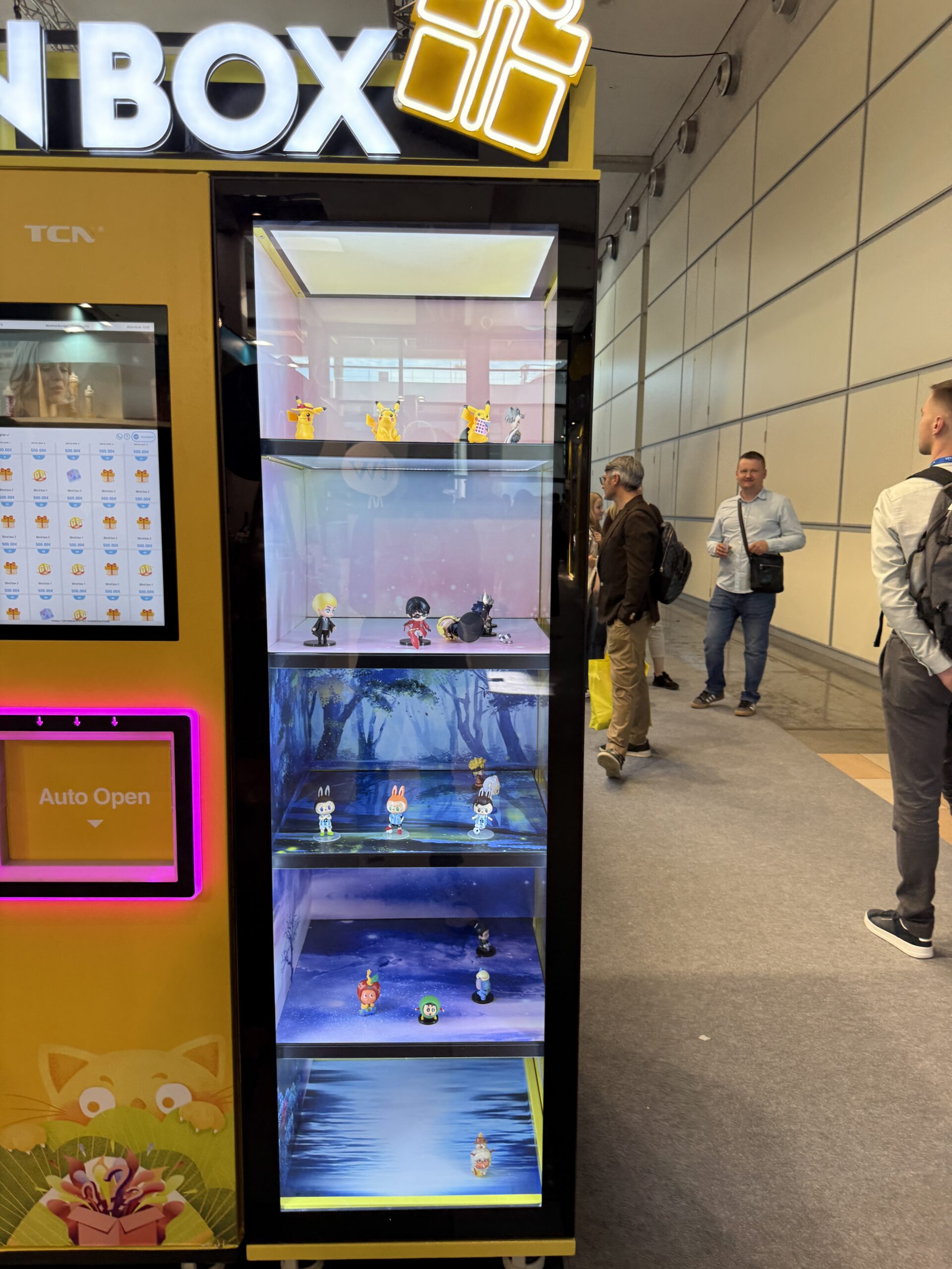 Touchscreen selection grid with per item pricing on a trading card vending machine