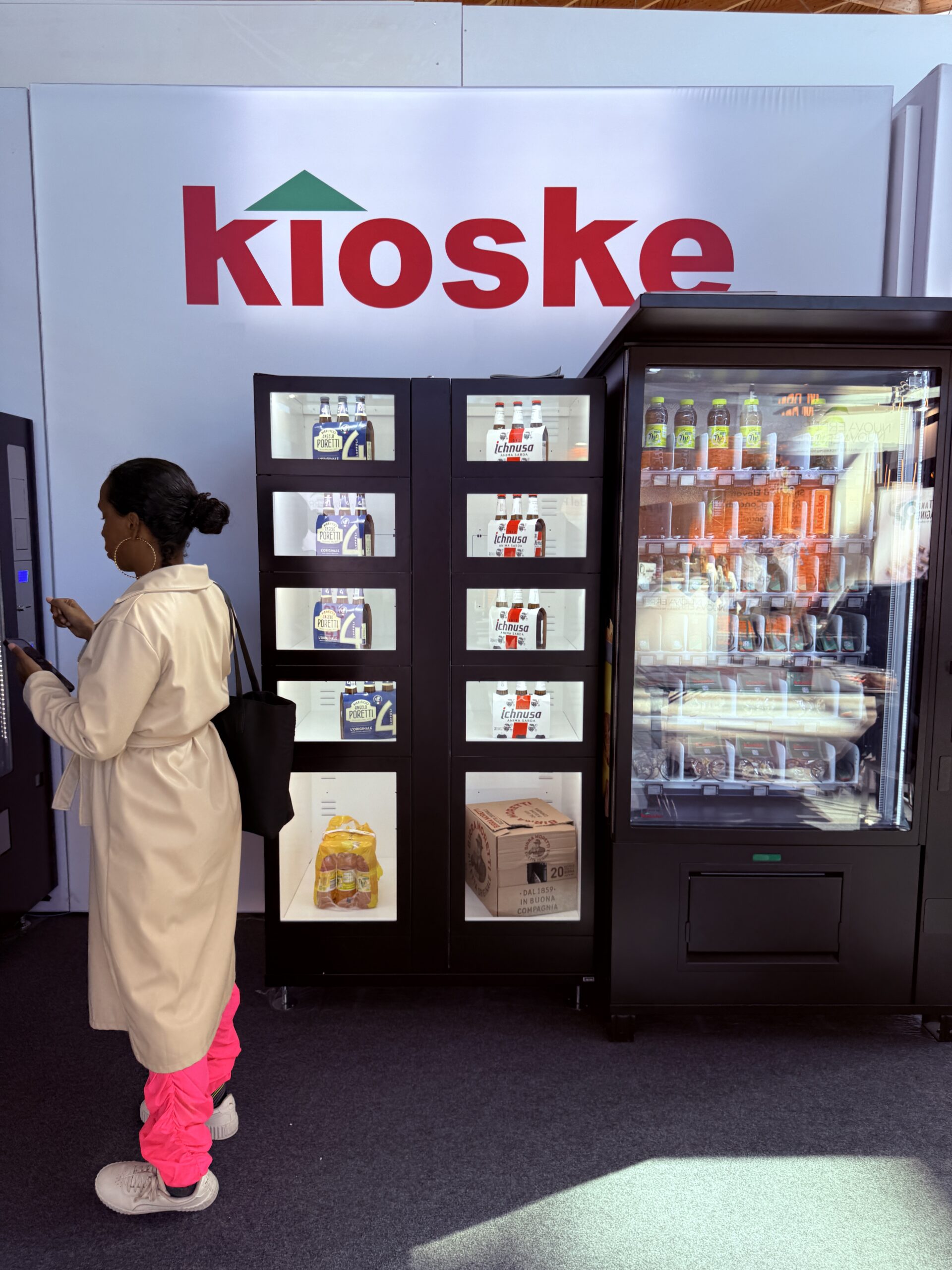 European automated kiosk with locker cabinets and a glass front vending machine