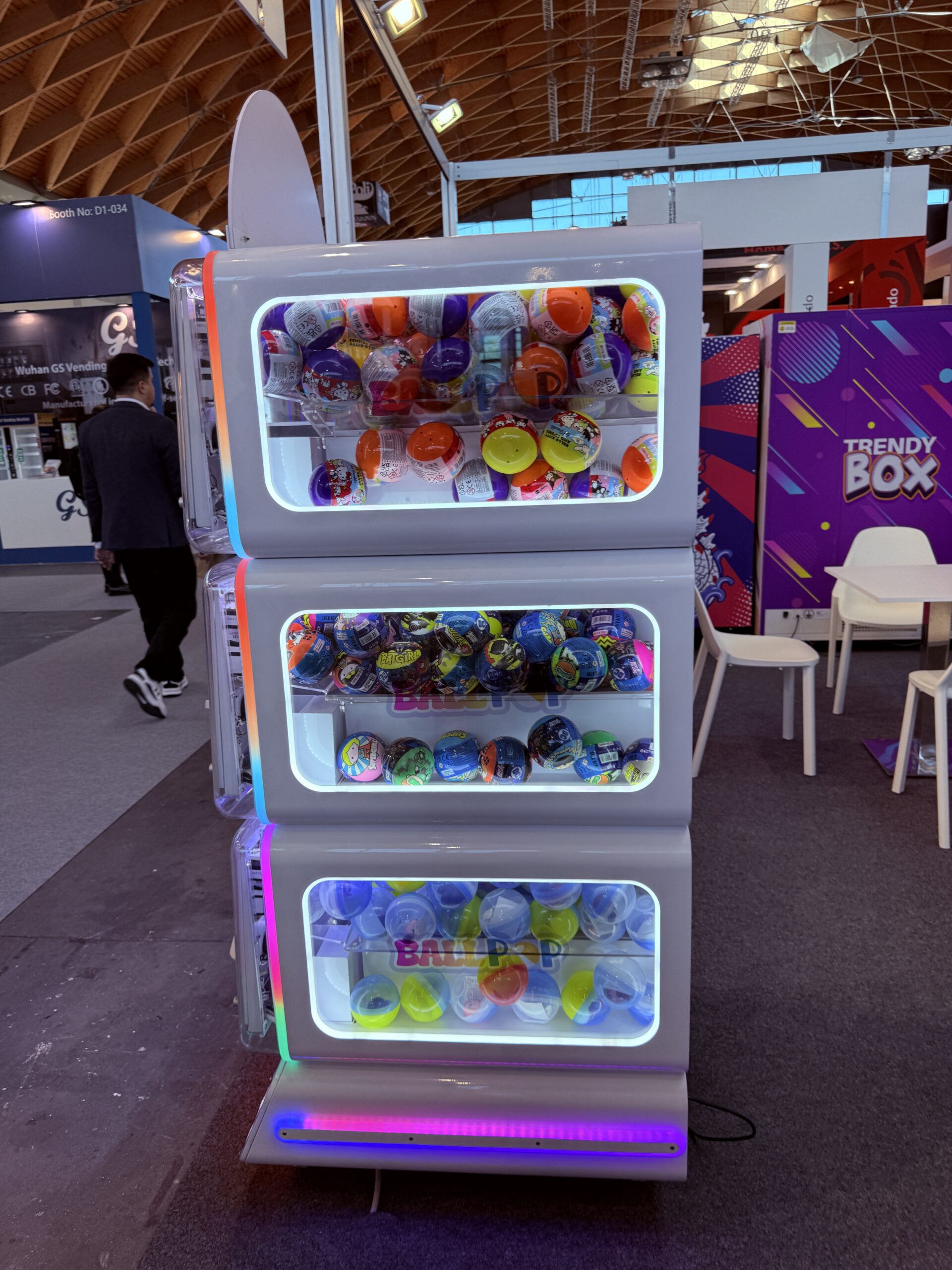 Stacked mystery ball capsule vending machines with lit display windows