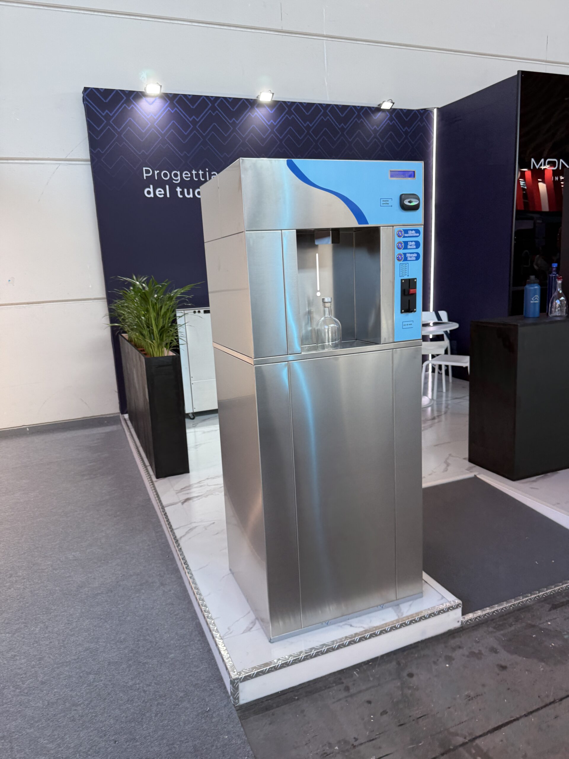 Stainless steel water refill vending machine dispensing filtered water into a bottle