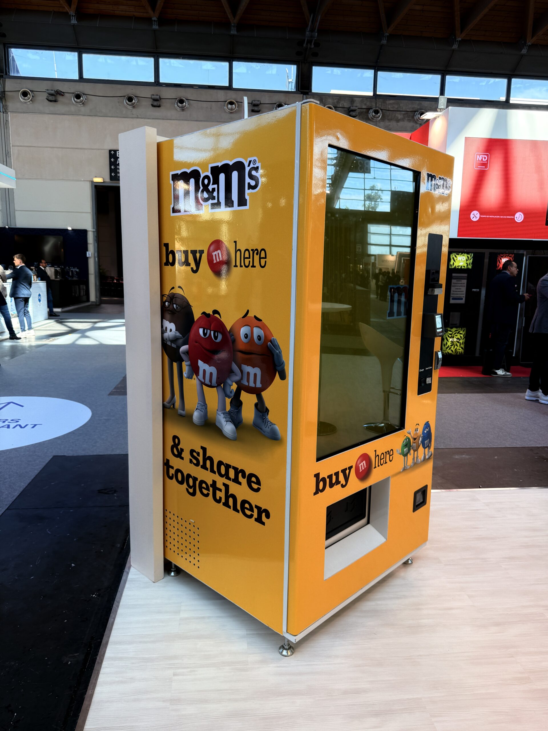 Branded vending machine with full surface graphics in a public venue